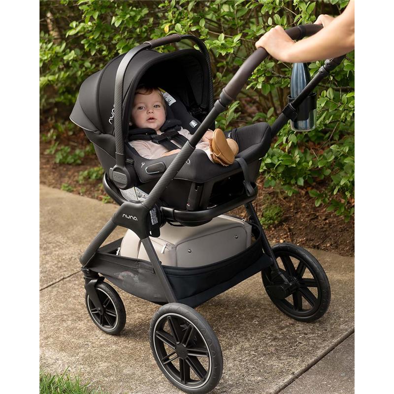 Nuna Triv Lx stroller with Pipa Urbn infant car seat, featuring a child seated comfortably and a water bottle attached.