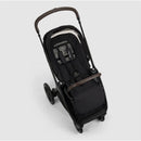 Nuna Triv Lx stroller with a black fabric seat and brown handlebar, designed for infants and toddlers.