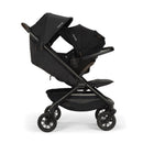 Nuna Trvl 360 Compact Stroller in Caviar, featuring a sleek black design and adjustable canopies for comfort.