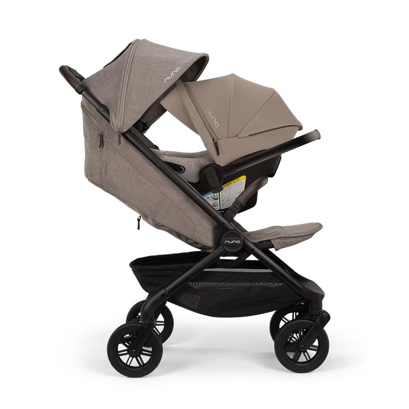 Nuna Trvl 360 Compact Stroller in Cedar color, featuring a reclining seat, adjustable canopy, and storage basket.
