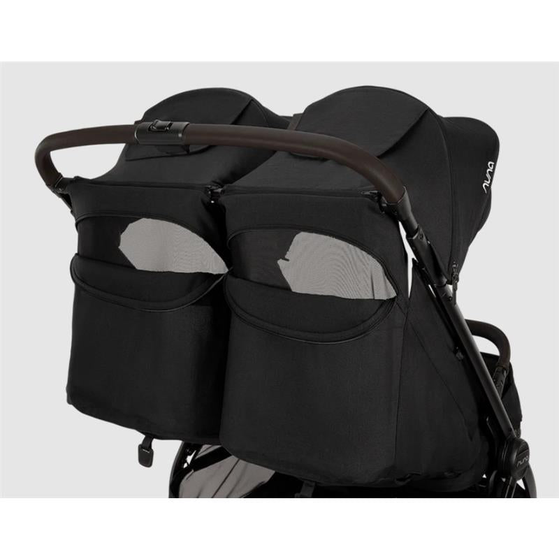 Lightweight Nuna TRVL Dubl side-by-side double stroller in Caviar with two hoods and mesh storage pockets.