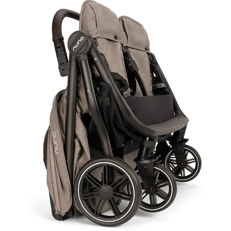 Lightweight Nuna TRVL Dubl side-by-side double stroller in Cedar color, featuring two seats, adjustable canopies, and sleek black wheels.