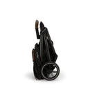 Nuna TRVL™ lx stroller in Caviar color, neatly folded for storage or travel, showing sleek design and wheels.