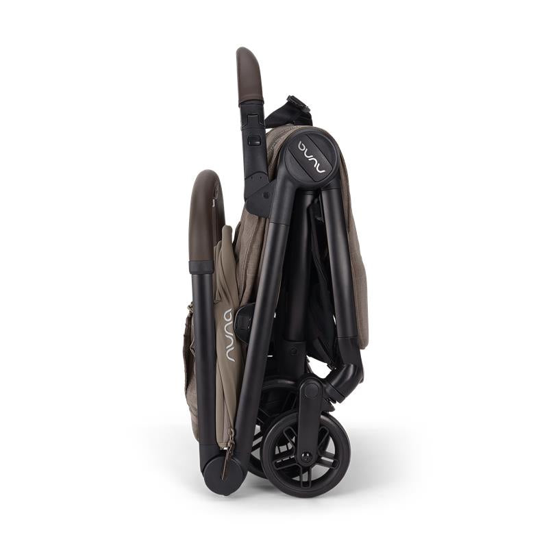 Nuna VIAA™ cabn Ultra-Compact Stroller in Cedar color, folded for easy transport and storage.