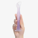 Diaper rash cream applicator with a suction base, held in a hand, featuring a gradient blueberry color design.