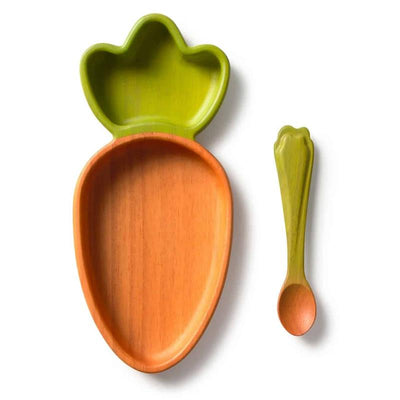 Carrot-shaped plate with an orange interior and green leaf design, accompanied by a matching green spoon.