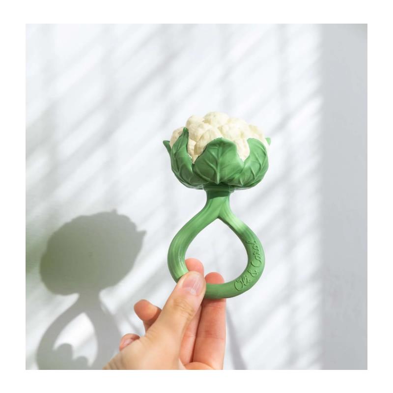 Oli & Carol Cauliflower Rattle Toy held by a hand, featuring a soft, textured cauliflower design with green leaves.