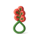 Bright red tomato-shaped rattle toy with a green handle, designed for infants to grip and play with.