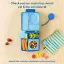 OmieBox in blue features a divided container with carrots, kiwi, and a salad, alongside utensils and a colorful napkin.