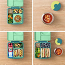 OmieBox in lime and meadow colors, featuring divided compartments filled with healthy foods like veggies, fruits, and sandwiches.