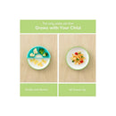 Toddler plate in green with divider, showing two meal presentations: separated foods on the left and a mixed meal on the right.