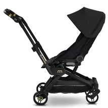 Compact black Orbit Baby M+ stroller with a large canopy, adjustable seat, and gold accents, shown from the side.