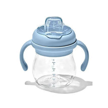 Oxo 6 oz sippy cup with soft spout and removable blue handles, showcasing measurement markings on a transparent container.