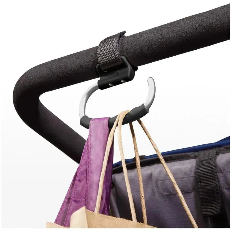 Oxo 2Pk Tot Handy Stroller Hook holding bags on a stroller handle, featuring a grey clip and a secure strap.