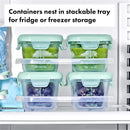 Oxo Tot Glass Baby Blocks in stackable trays, featuring green and purple food storage containers in a refrigerator.
