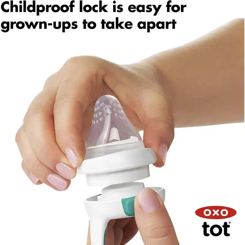 Childproof lock feature being easily operated by an adult hand on an OXO Tot silicone feeder replacement.