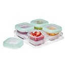 Oxo Tot Baby Blocks food storage containers with mint-green lids, holding pureed foods and fruits on a clear tray.