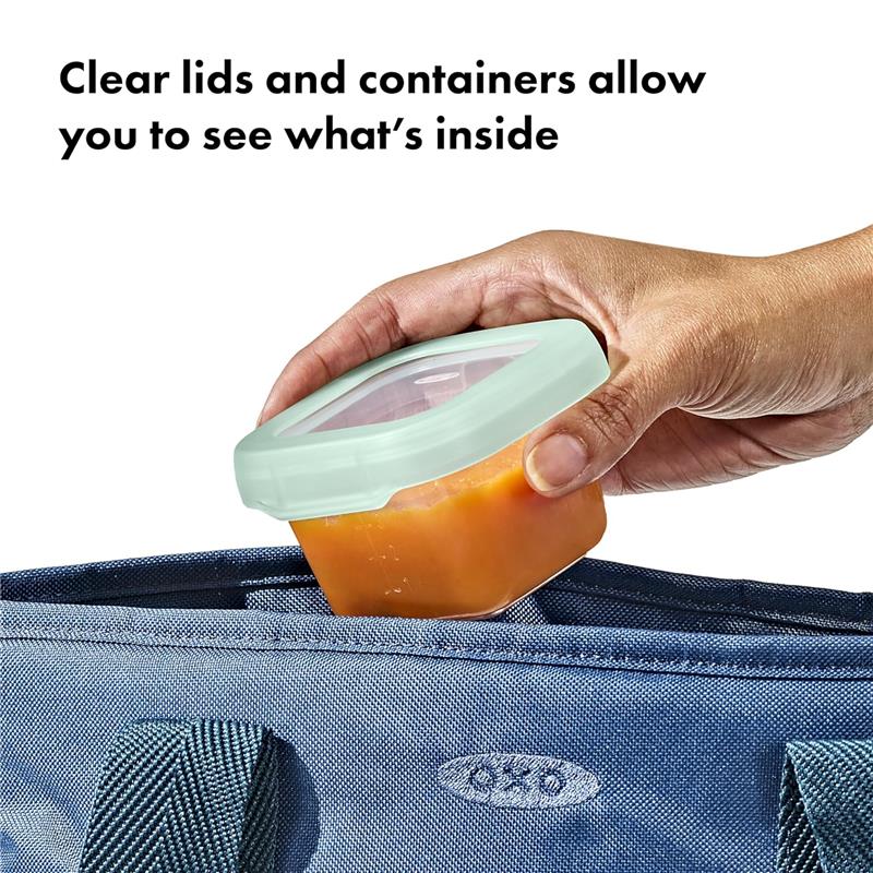 Clear 4 oz Oxo - Tot baby food storage container with a light green lid, being placed into a blue bag.