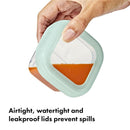 Oxo Tot Baby Blocks food storage container, 4 oz, with orange food inside and a mint green airtight lid.