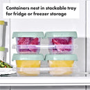 Oxo Tot Baby Blocks Food Storage Container set in a stackable tray, with colorful frozen purees visible inside each container.
