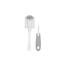 OXO Tot Bottle Brush with a white bristle head and a gray ergonomic handle, accompanied by a bristle cleaner.