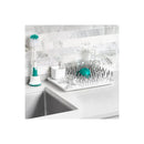 OXO Tot Bottle Drying Rack in gray with multiple prongs, bottles, and a bottle brush on a kitchen countertop.