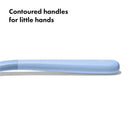 Oxo Tot cutlery in dusk color features contoured handles designed for little hands.