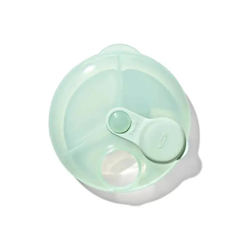 OXO Tot Formula Dispenser in opal color, featuring three compartments and a lid with a scoop for easy dispensing.