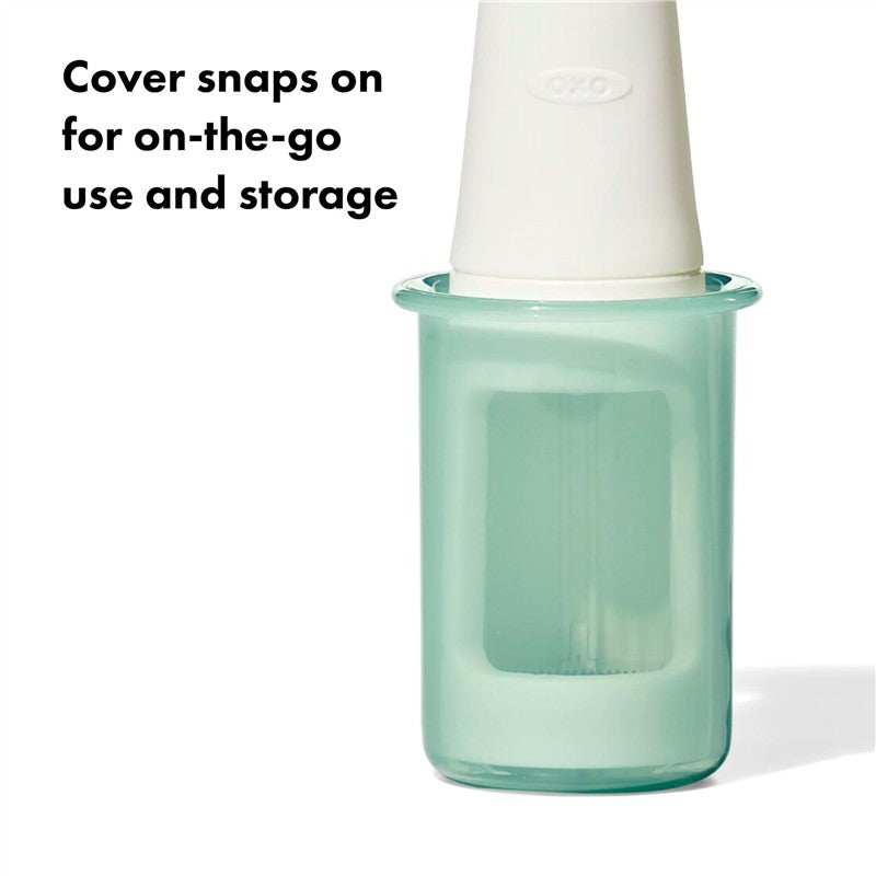 OXO Tot Grape Cutter in opal color with a white cover; designed for safe cutting of grapes and easy storage.