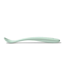 Soft green plastic feeding spoon designed for infants, featuring a curved handle and shallow bowl.