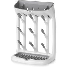 OXO Tot Space Saving Drying Rack in gray features a sleek design with multiple slots for bottles and accessories, and a draining tray.
