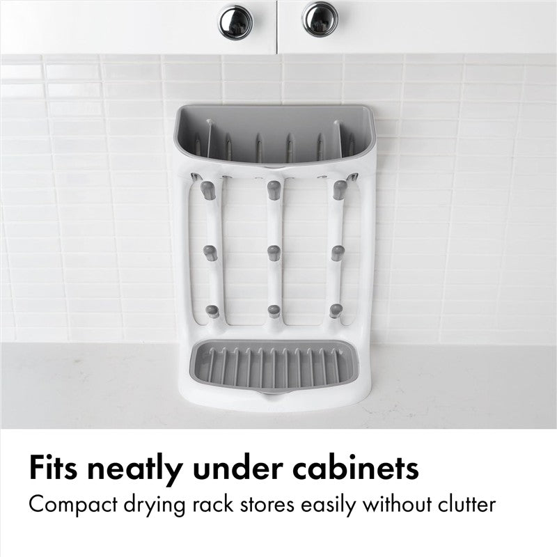 Compact gray drying rack with vertical slots for dishes, designed to fit under cabinets without clutter.