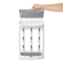 OXO Tot Space Saving Drying Rack in gray, featuring a removable top tray and vertical drying slots for baby bottles.