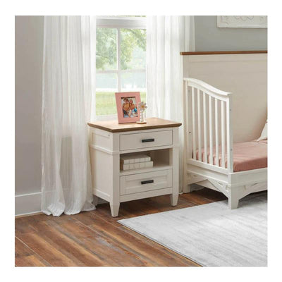 Parker House Artisan nightstand in white with a wood top, featuring two drawers and a photo frame beside a crib.