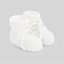 Knit newborn booties in soft white with a textured pattern and ties, designed for infant comfort.