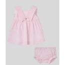 Baby dress and bloomer set in chalk pink, featuring a bow detail and textured fabric.