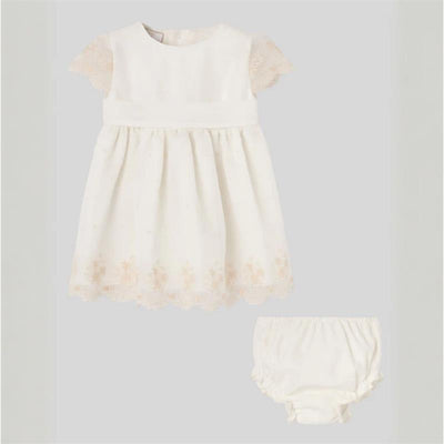 Cream dress with lace cap sleeves and floral hem, paired with matching cream bloomer for babies.