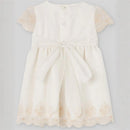 Cream-colored baby dress featuring short lace sleeves, a ribbon tie at the waist, and floral embroidery at the hem.