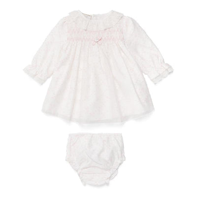Light pink newborn dress with long sleeves, smocked detail, and matching bloomers. Perfect for infants.