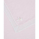 Paz Rodriguez Alaia blanket in chalk pink and white, featuring a textured design and a decorative white bow with a pearl.