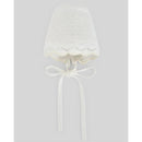 Knit baby hat in chalk pink and cream, featuring a scalloped edge and ties, designed for warmth and style.