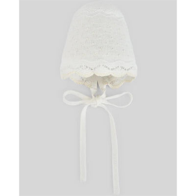Knit baby hat in chalk pink and cream, featuring a scalloped edge and ties, designed for warmth and style.