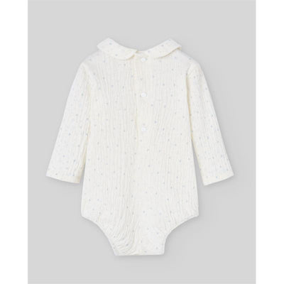 Knit newborn bodysuit by Paz Rodriguez in cream with powder blue dots and a classic collar.