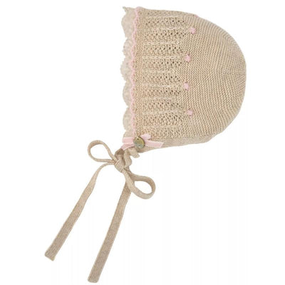 Knit newborn bonnet in light brown and chalk pink with decorative trim and ties, ideal for baby outfits.