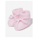 Knit newborn booties in soft pink, featuring a cuff and tie detail. Ideal for keeping little feet warm and stylish.