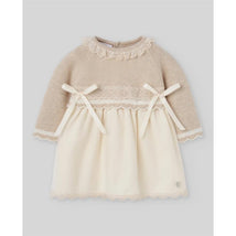 Knit newborn dress in light brown and cream, featuring lace trim and bows at the waist and neckline.