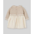 Knit newborn dress by Paz Rodriguez in light brown and cream, with lace detailing and button closure at the back.