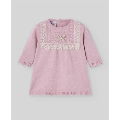 Knit newborn dress in powder pink with light brown lace trim, featuring a bow and pearl detail on the chest.