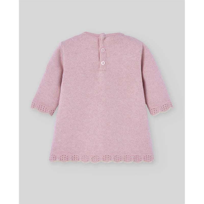 Knit newborn dress in powder pink, featuring three-quarter sleeves, a scalloped hem, and button closure at the back.