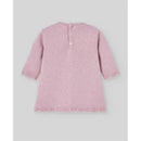 Knit newborn dress in powder pink, featuring three-quarter sleeves, a scalloped hem, and button closure at the back.